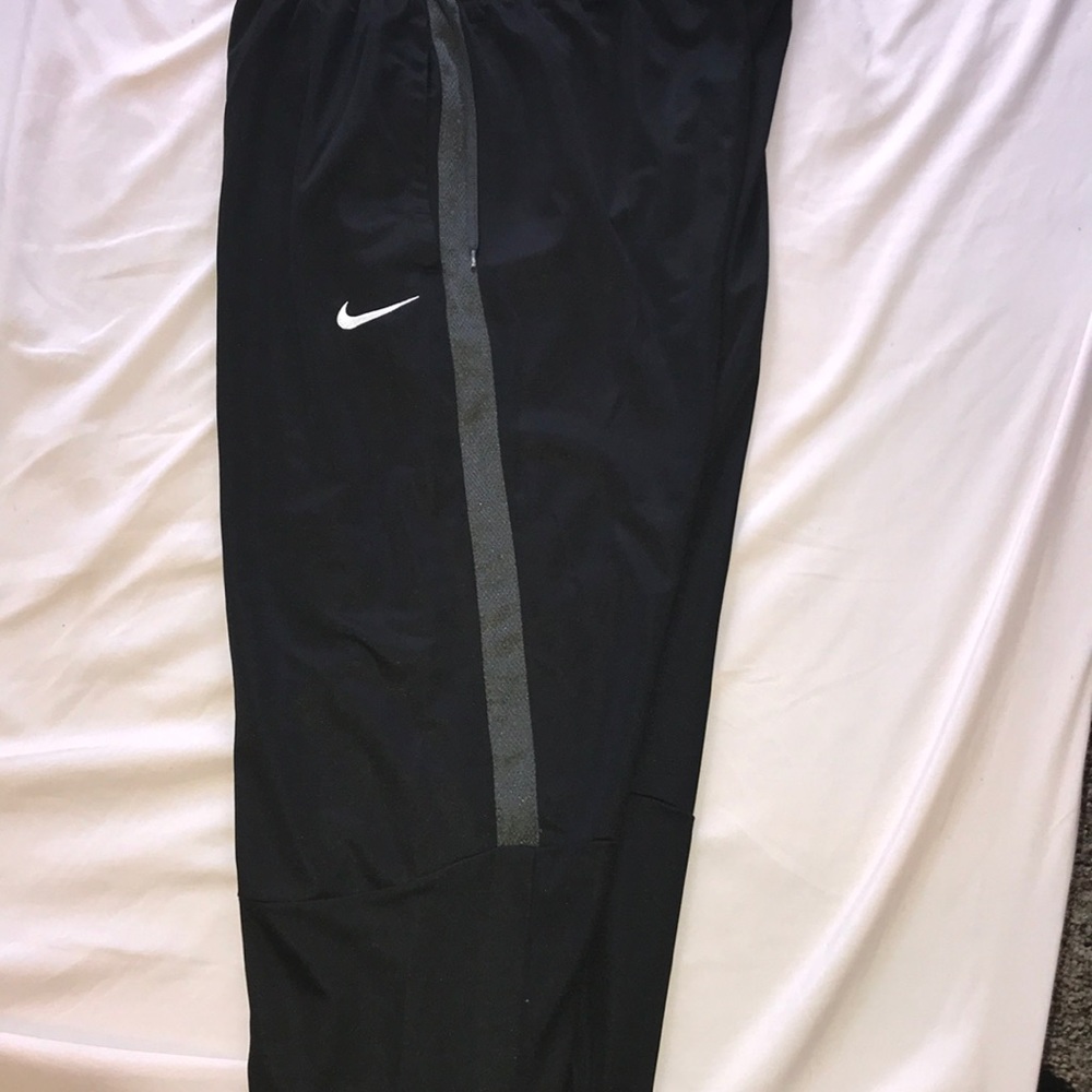 Black and gray Nike sweats with white swoosh